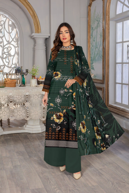Woman in a green embroidered outfit standing in an elegant room with decorative elements.